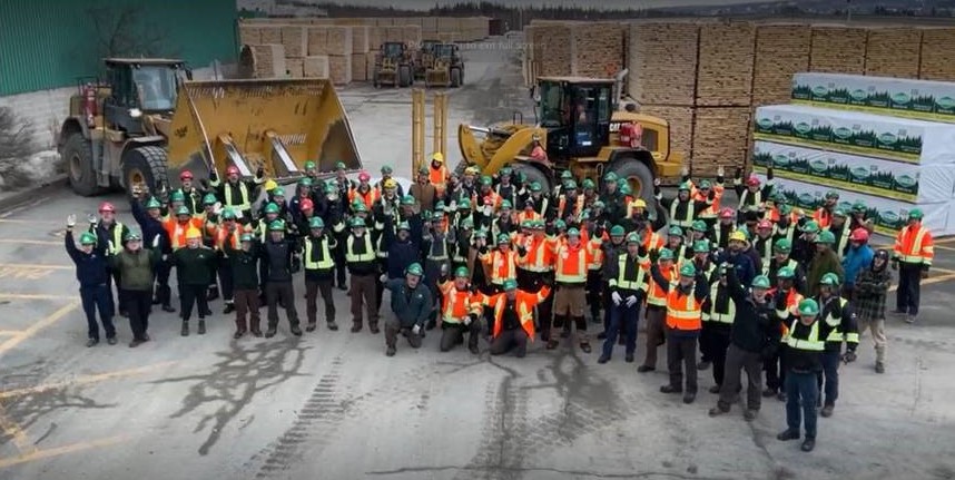 Group photo of the Saint Leonard sawmill team cheering