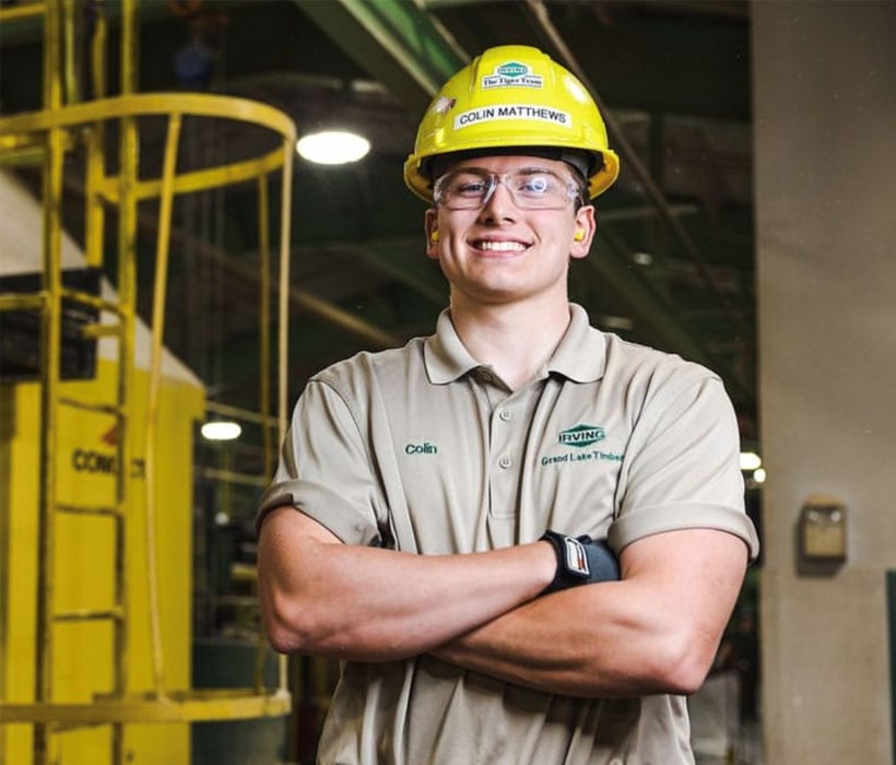 Collin Matthews at work smiling with arms crossed