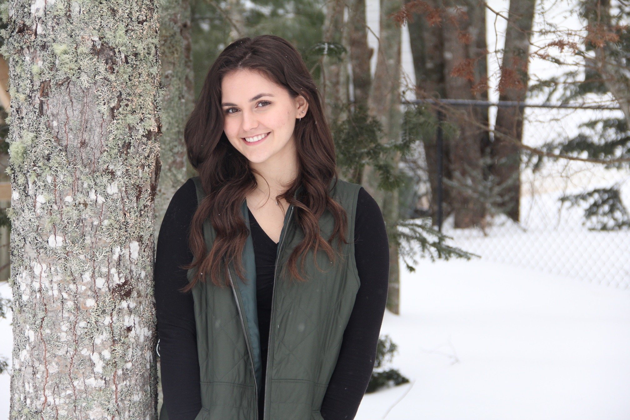 Hadley Bent, leaning against a snowy tree
